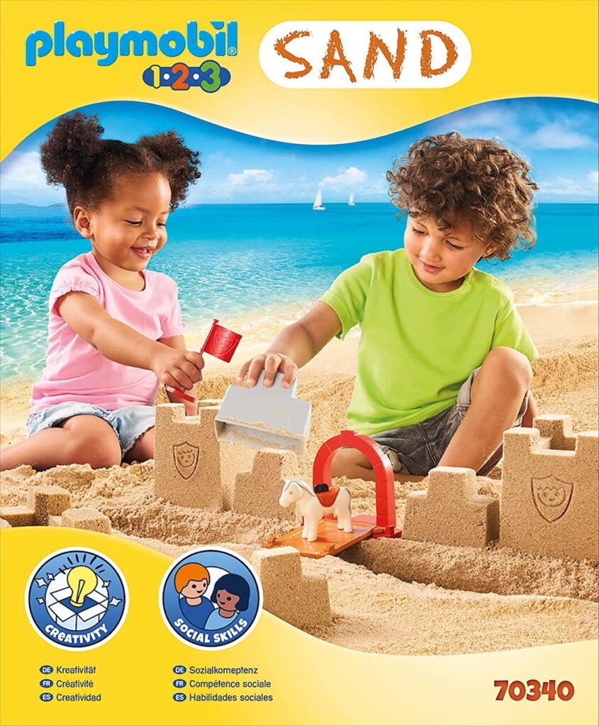 Kids playing with a sand castle set.
