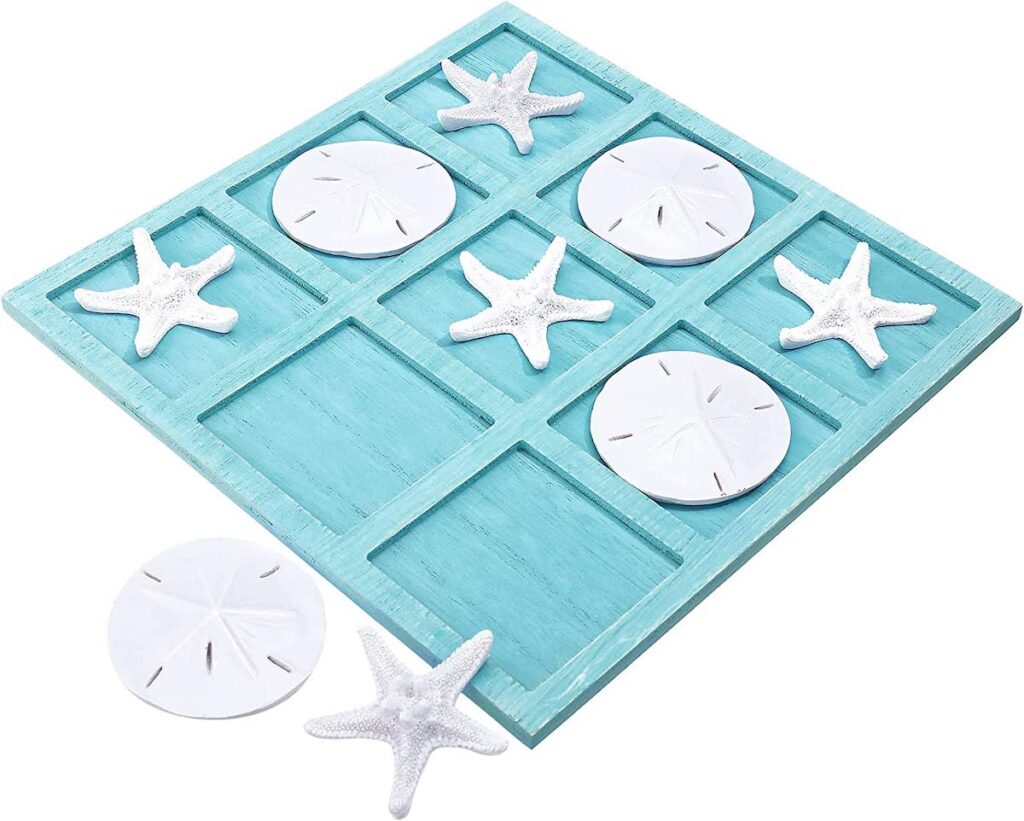 An aqua wood tic-tac-toe board and white shell and starfish playing pieces, to give as beach gifts.