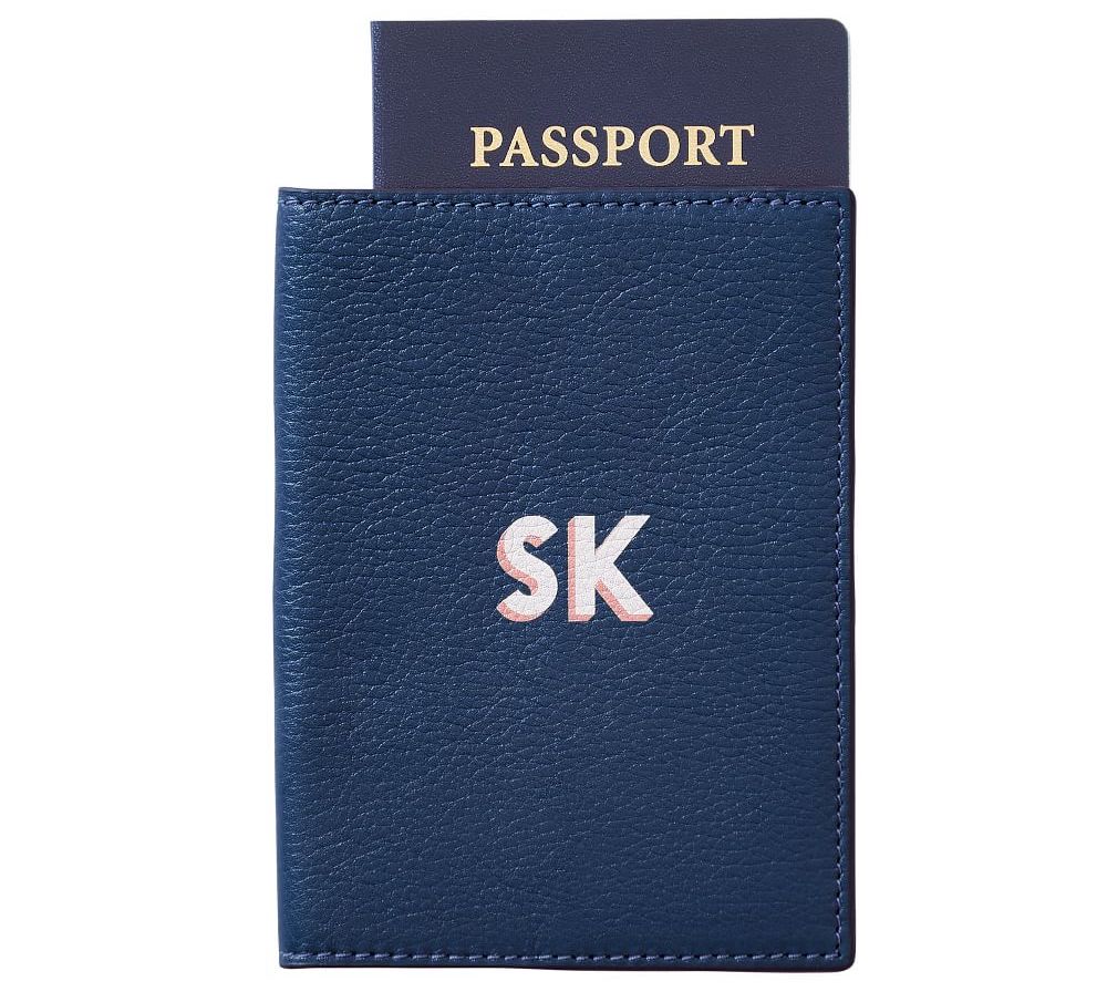 A navy leather passport case with shadow printed monogram.
