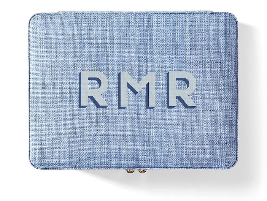 A blue raffia monogrammed travel jewelry case.