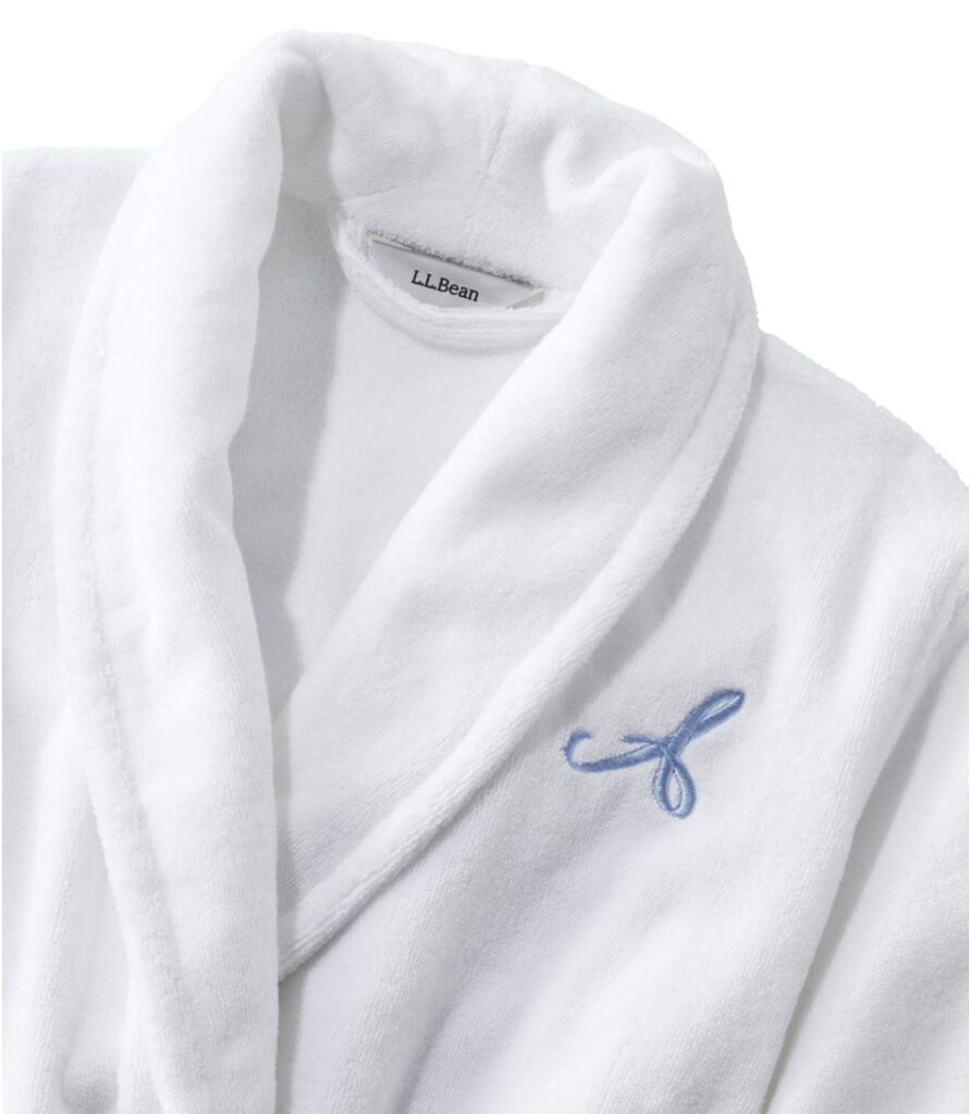 Women's white organic terry robe with a blue monogram on one side.