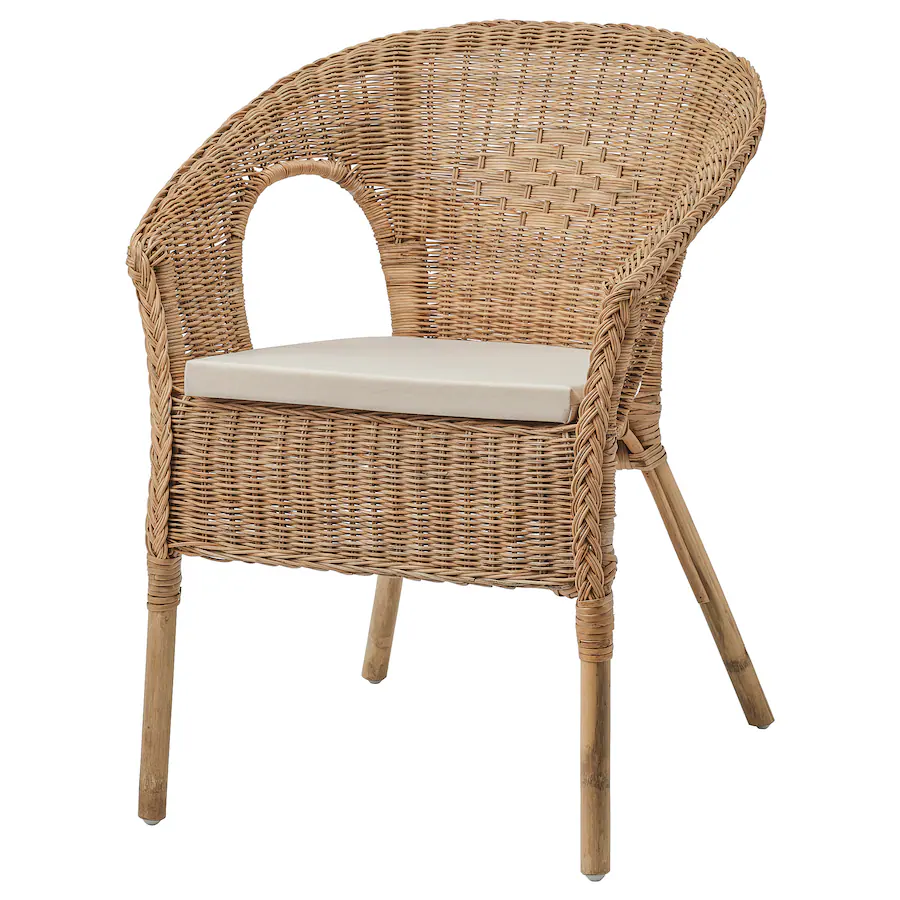 A rattan chair with a beige cushion.
