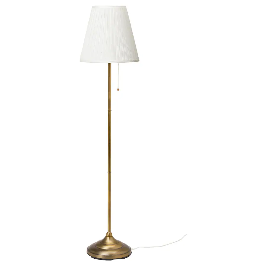 Brass floor lamp with white lampshade.