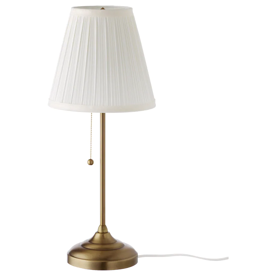 Brass table lamp with white shade.