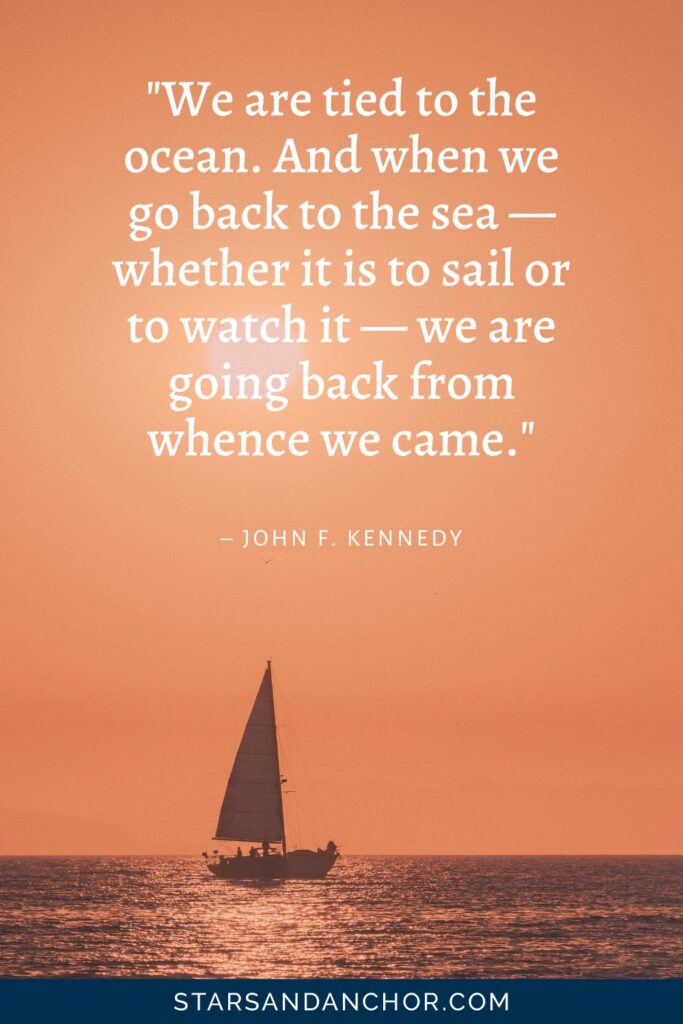 Photo of a sailboat at sunset, with the quote "We are tied to the ocean. And when we go back to the sea—whether it is to sail or to watch it—we are going back from whence we came." By John F. Kennedy. Graphic by Stars and Anchor.