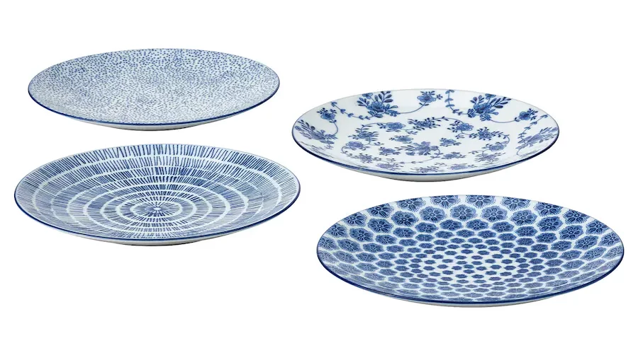 Four plates in various blue and white geometric and floral patterns.