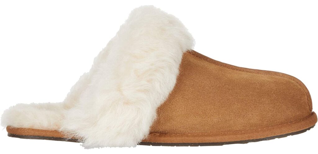 A chestnut brown slipper with shearling trim and lining.
