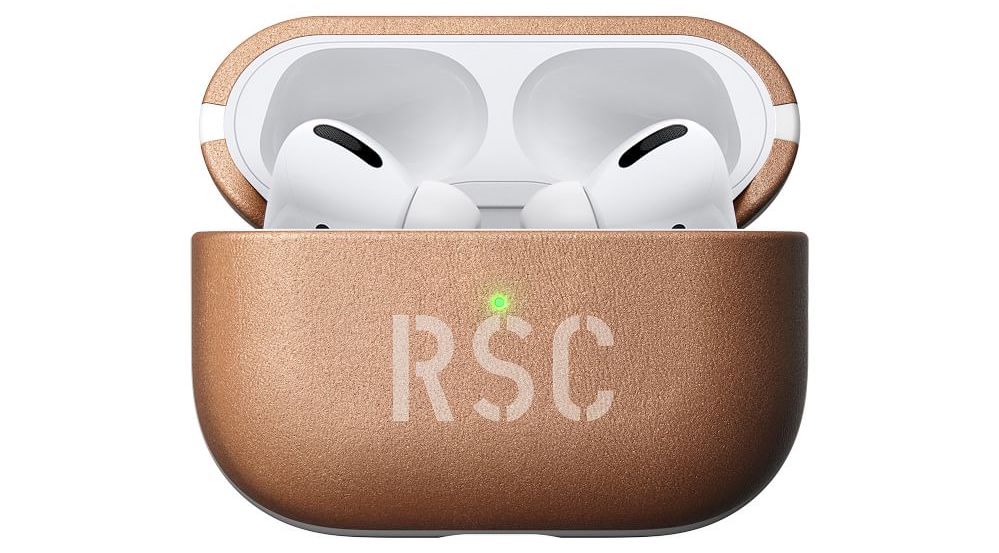 A light brown AirPods case monogrammed with the initials RSC.