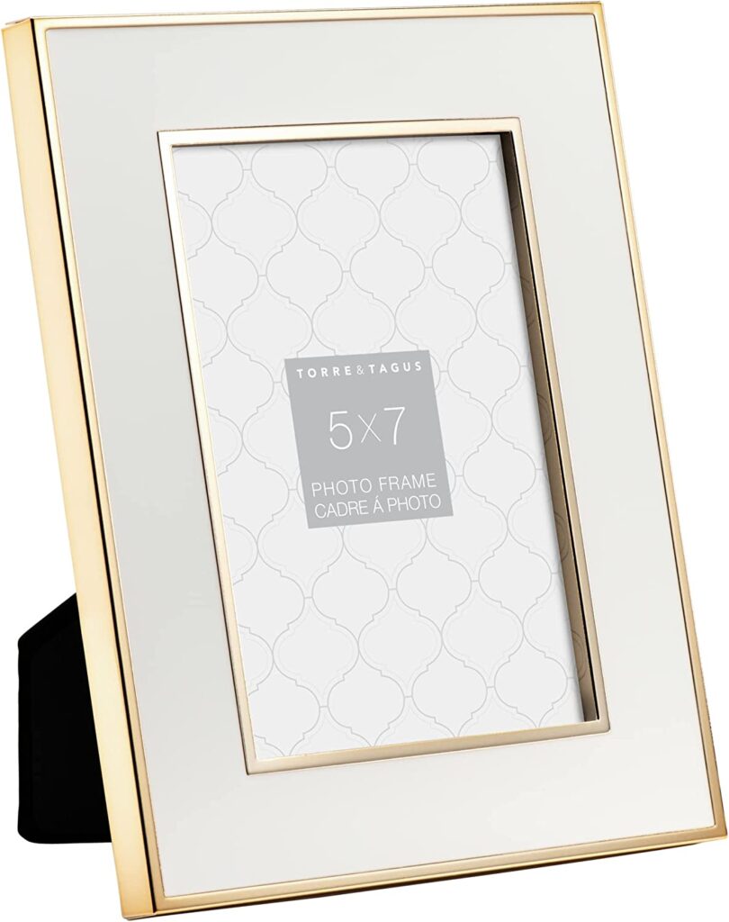 A white enamel picture frame with a gold border.