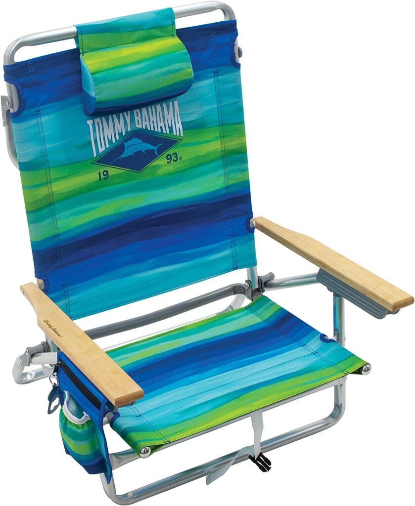 A blue and green beach chair with a head cushion that says "Tommy Bahama" and "1993" on it.