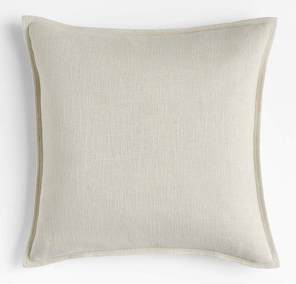 An ivory linen throw pillow.