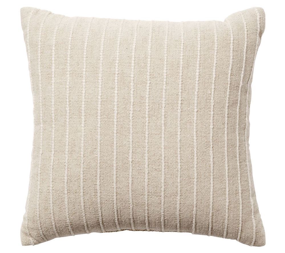 A neutral tan throw pillow with off-white thin textured stripes.