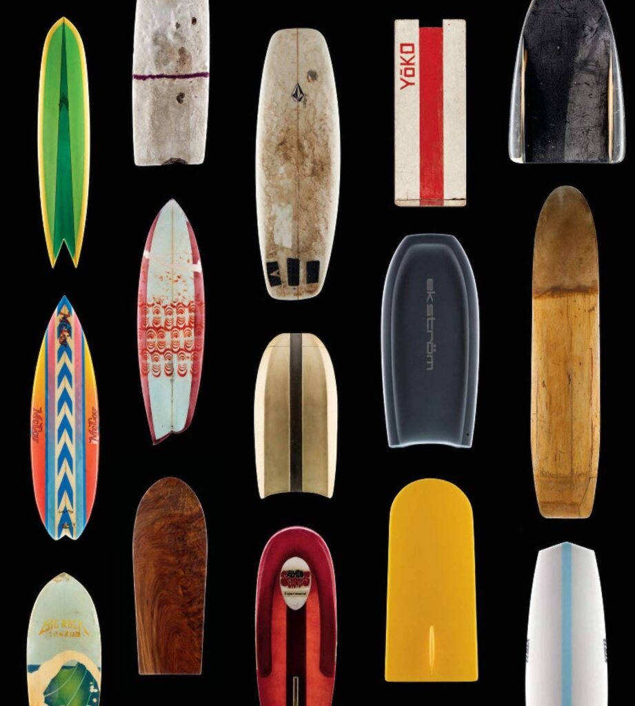 The cover of a surfing coffee table book with many different colors and style of surf boards. There is no title written on the cover.