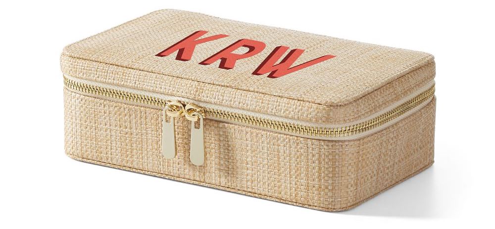 A raffia zip-close jewelry case with a monogram on the lid.