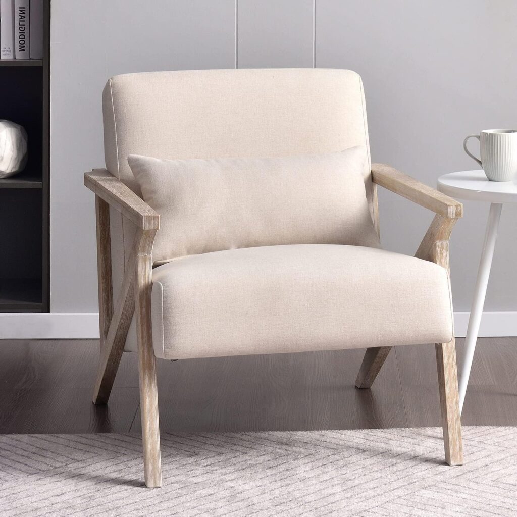 A beige accent chair in the mid-century modern style, shown in a living room setting.