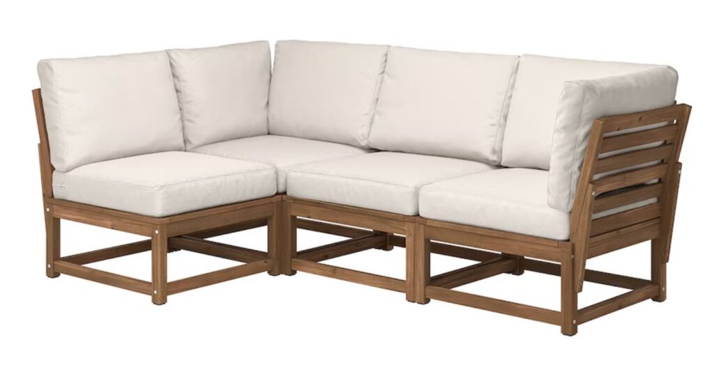 A wood outdoor sofa with beige cushions.