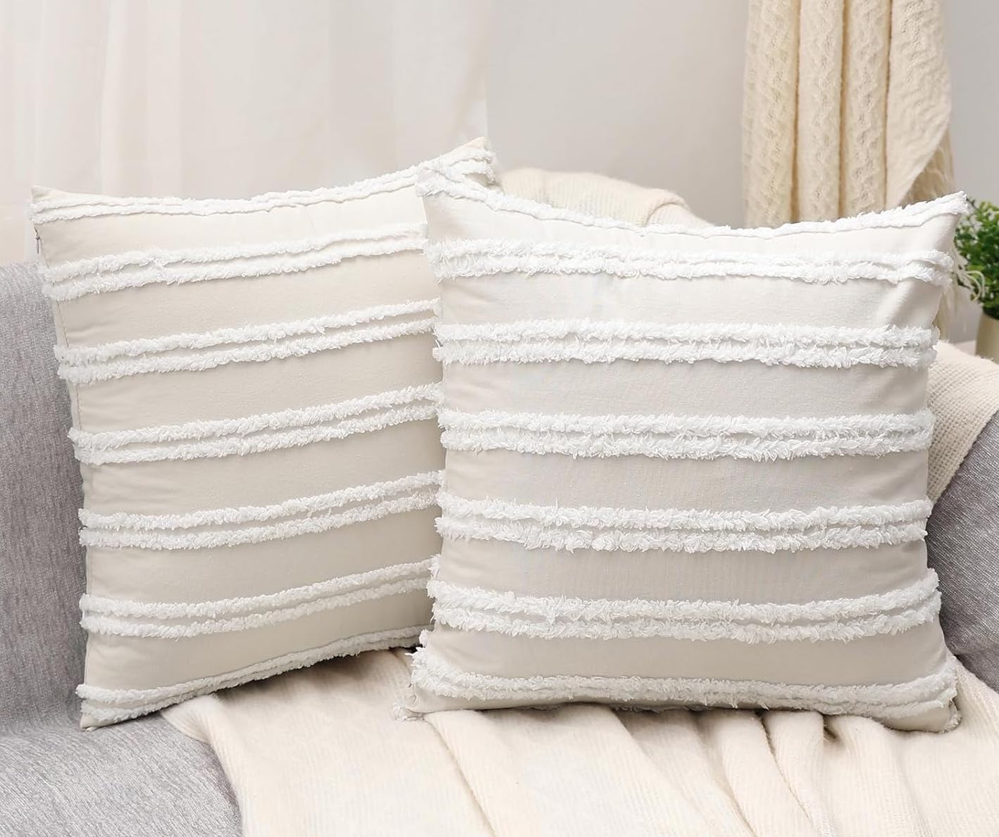 2 beige throw pillows with textured stripes.