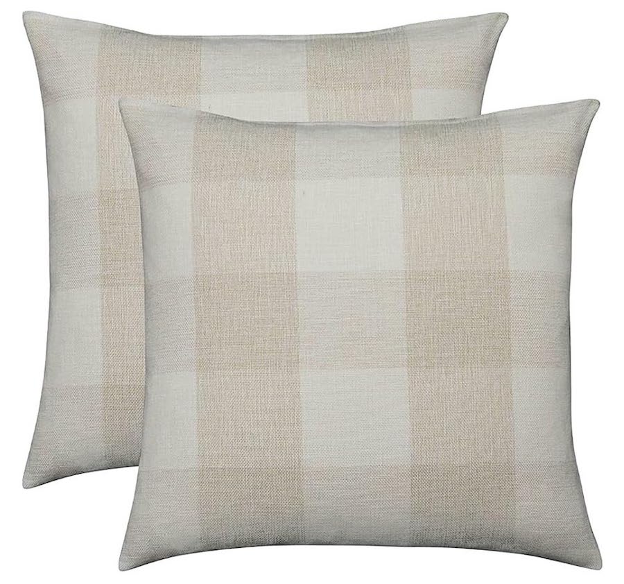 Two cream-colored throw pillows with a beige and light tan buffalo check pattern.
