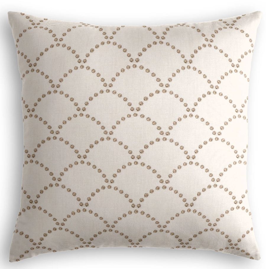 A beige throw pillow with an allover taupe scalloped pattern.