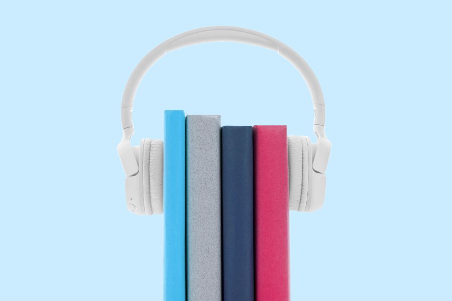 Four books with a pair of headphones around them.