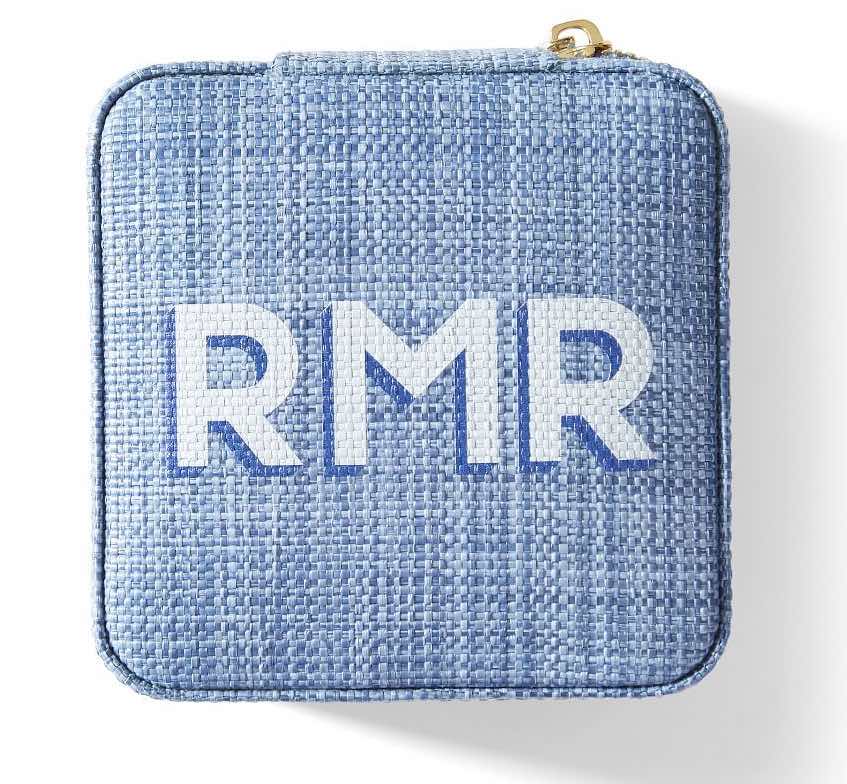 A blue rattan monogrammed jewelry case.