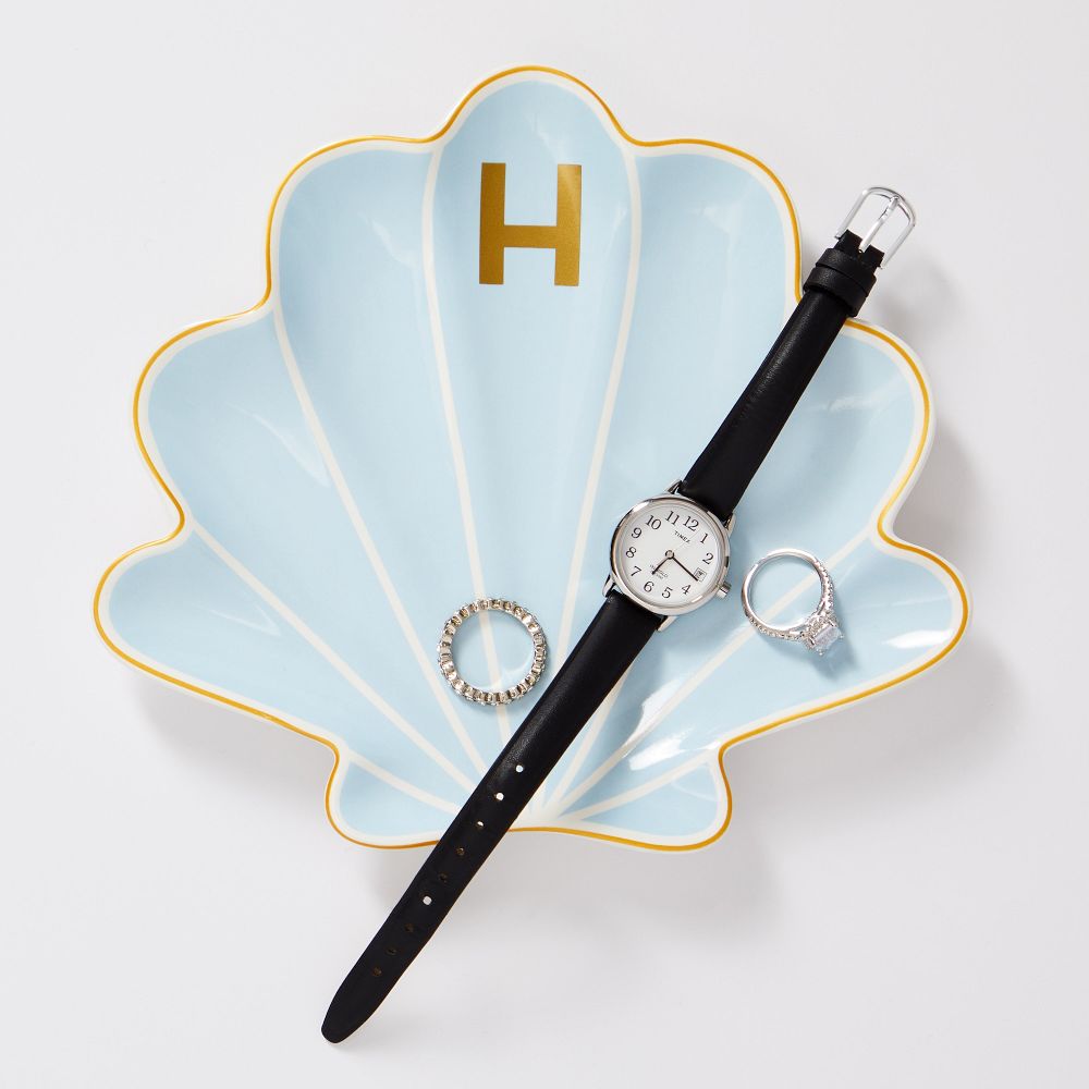 A shell ring dish with a monogram on it.