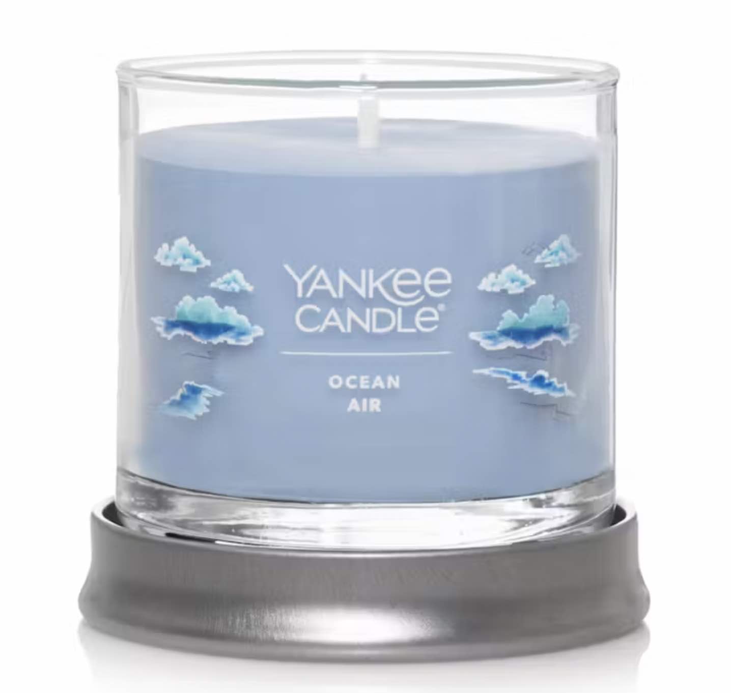 A light blue candle in a glass jar, the scent is "ocean air."
