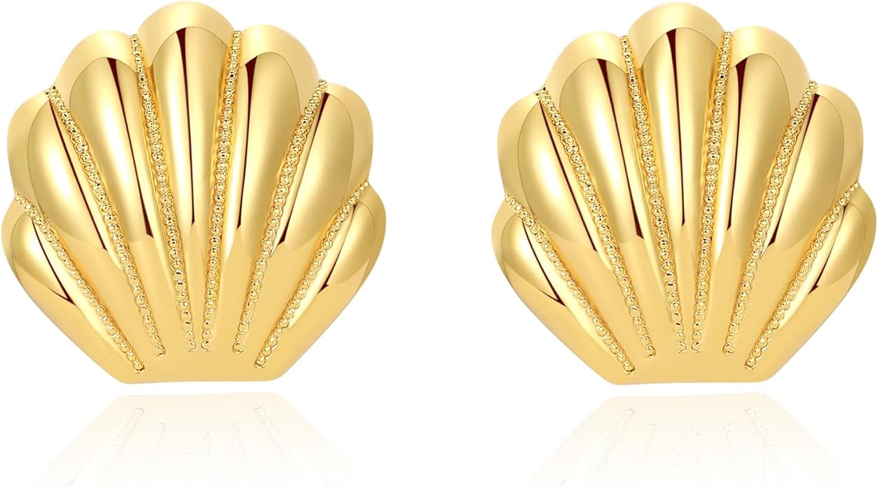 A pair of gold scallop seashell earrings.