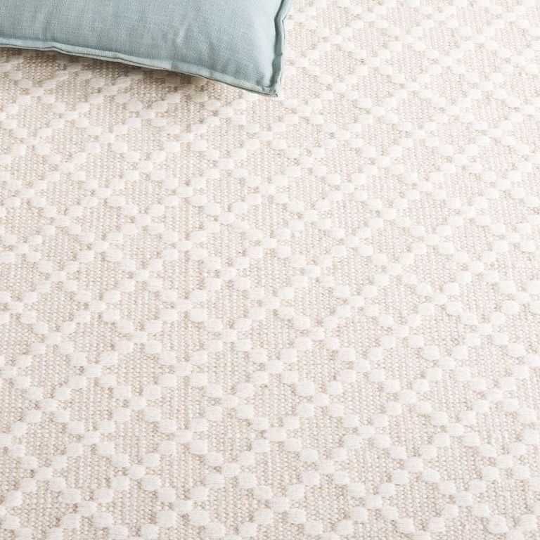 Detail of the beige and ivory woven diamond rug.