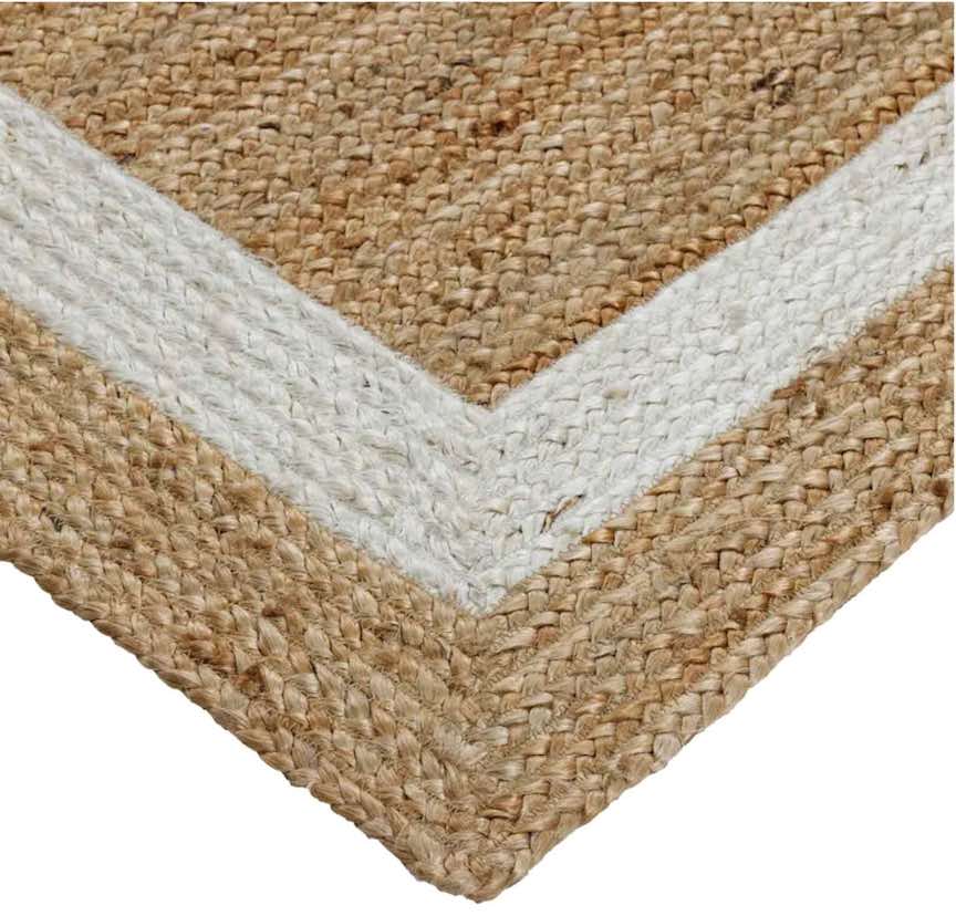 Closeup detail of natural jute area rug with a white inset border.