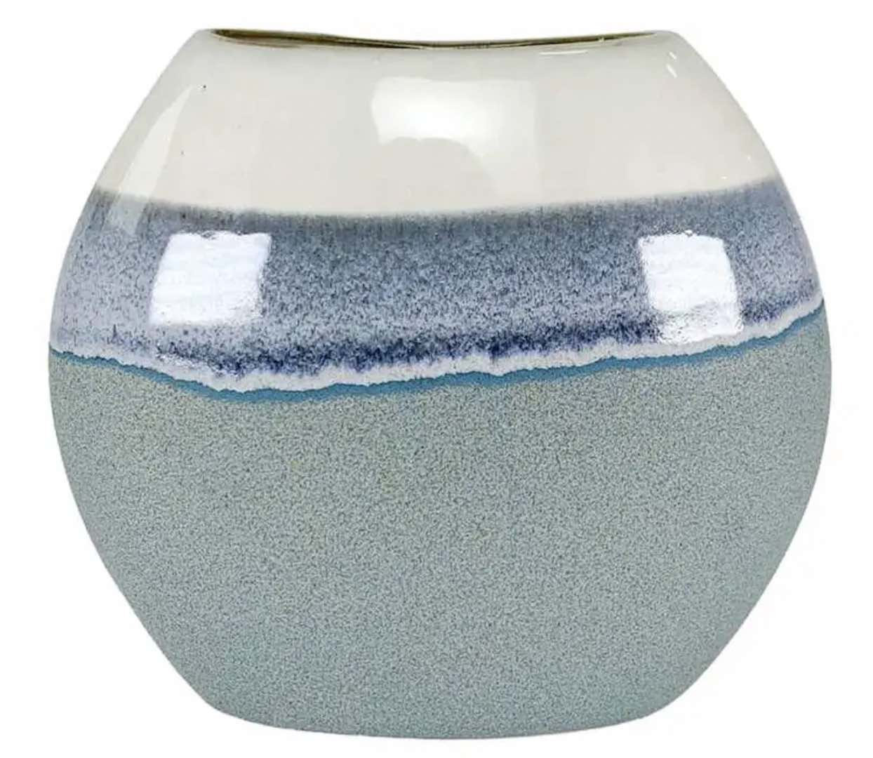 A ceramic vase with reactive glaze randing from off-white to blue to sea green.