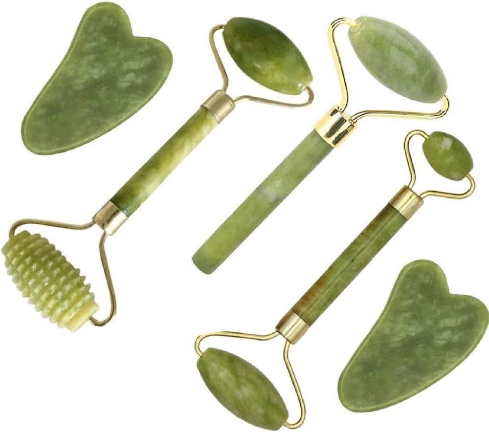 A 5-piece green and gold jade roller and Gua Sha set.
