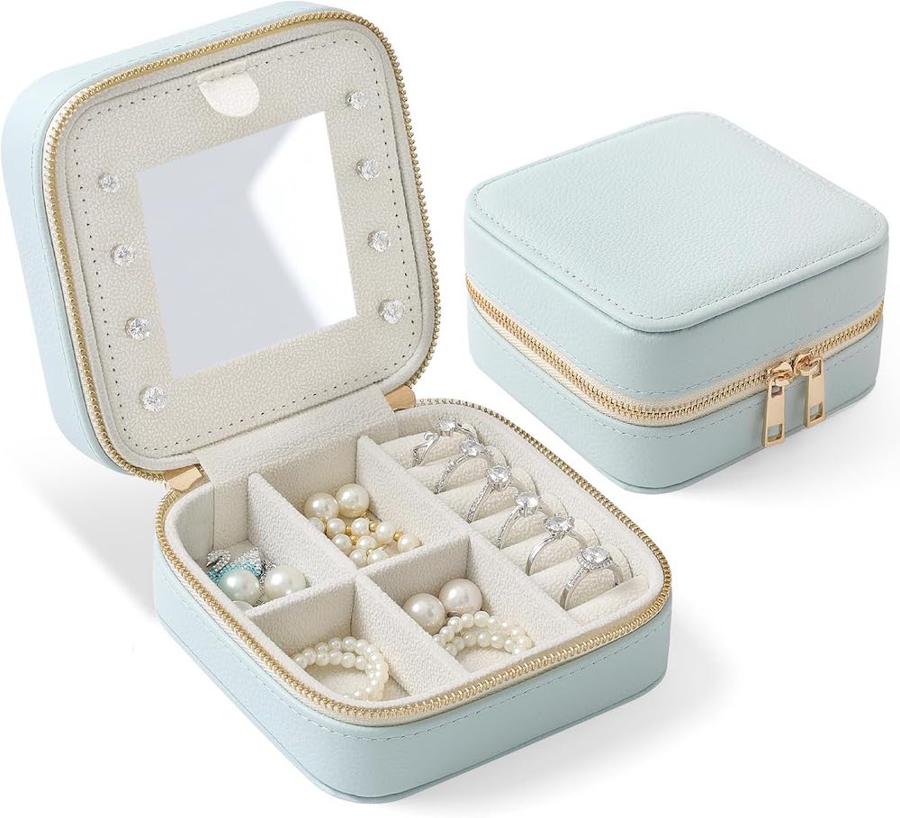 A light blue portable jewelry case with a gold zipper.