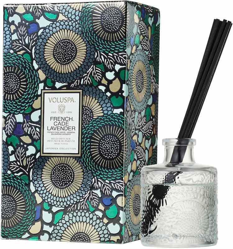 A floral box that says Voluspa French Cade Lavender, and a glass jar that has reeds sticking out of the top.