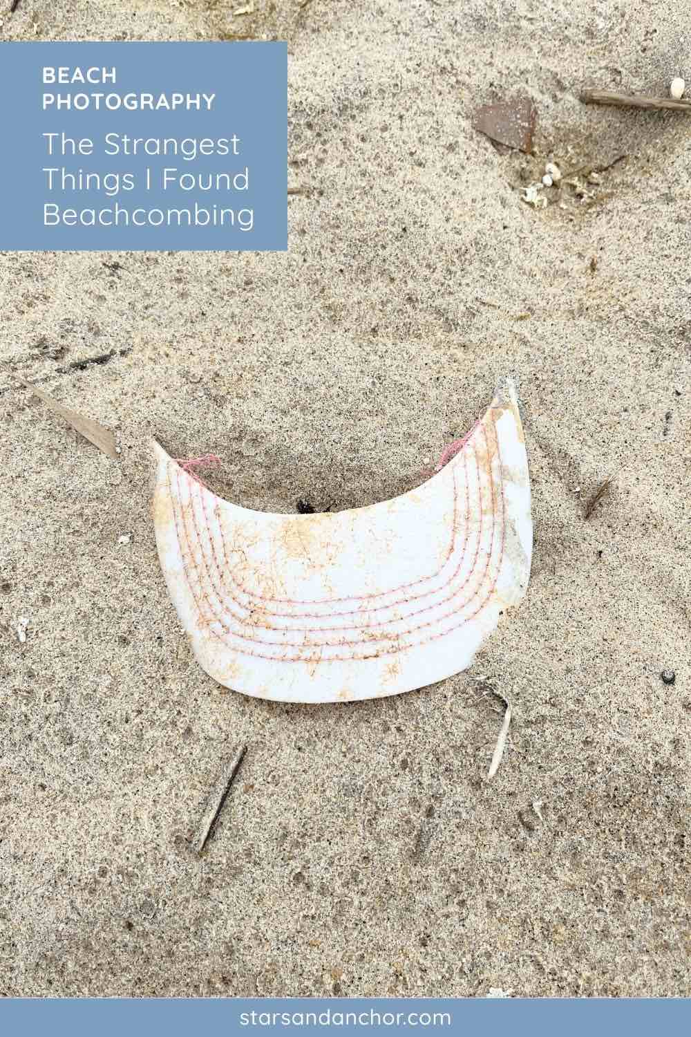 The brim to a baseball cap on the beach.