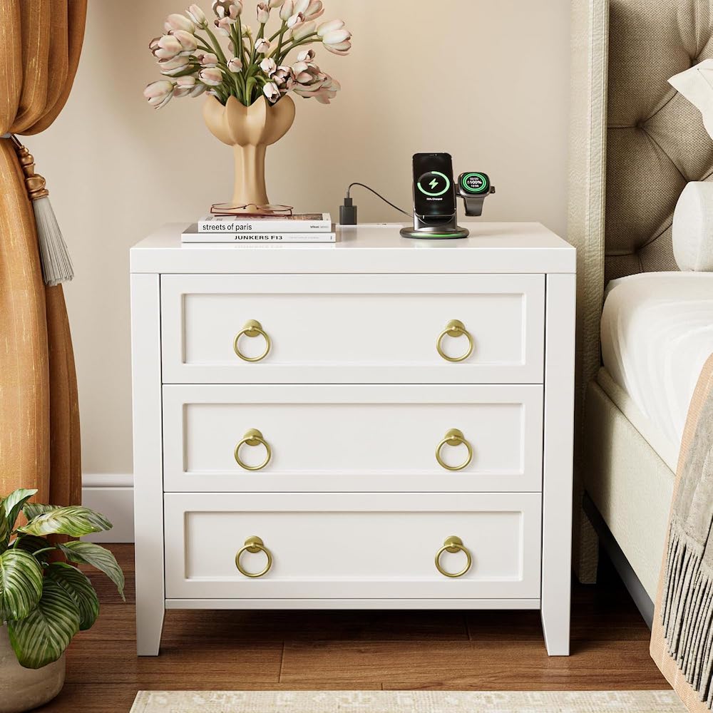 A white 3-drawer nightstand with gold ring pulls.