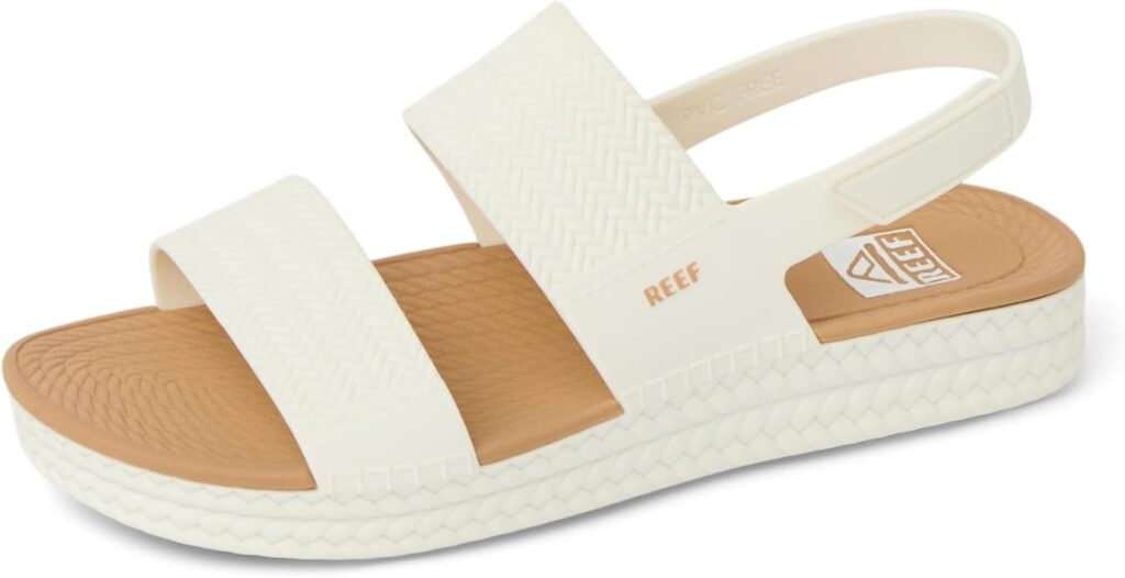 A pair of white and tan women's sandals.