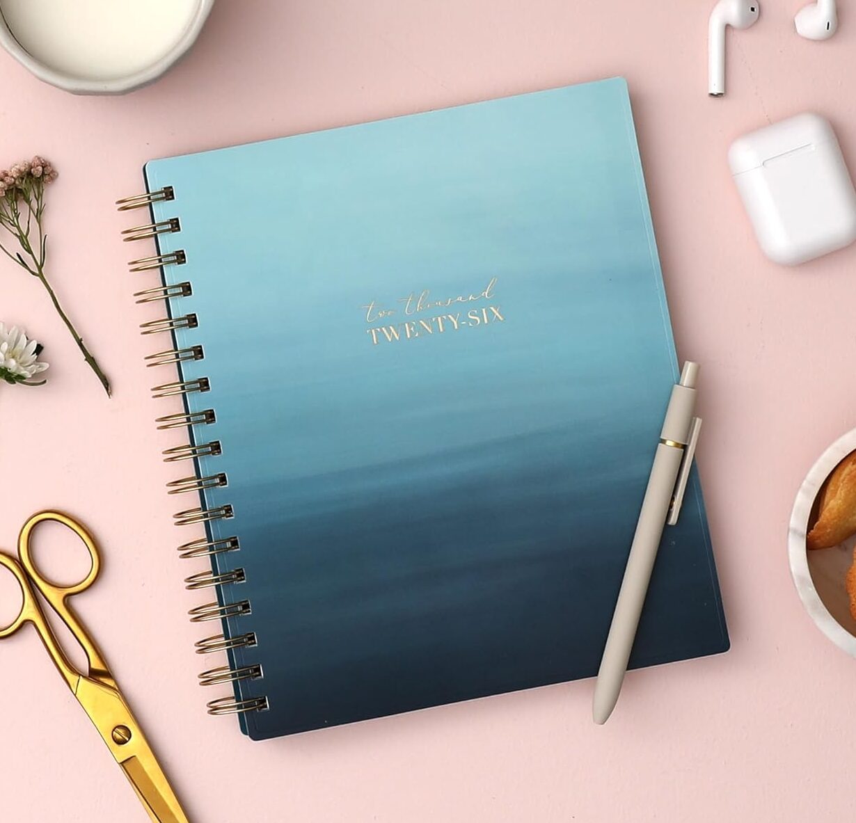 A 2026 planner with a light blue to navy blue watercolor background.