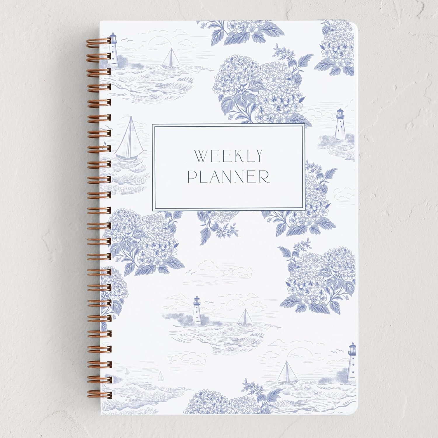 A white Weekly Planner with blue sailboats, hydrangeas, and light houses.
