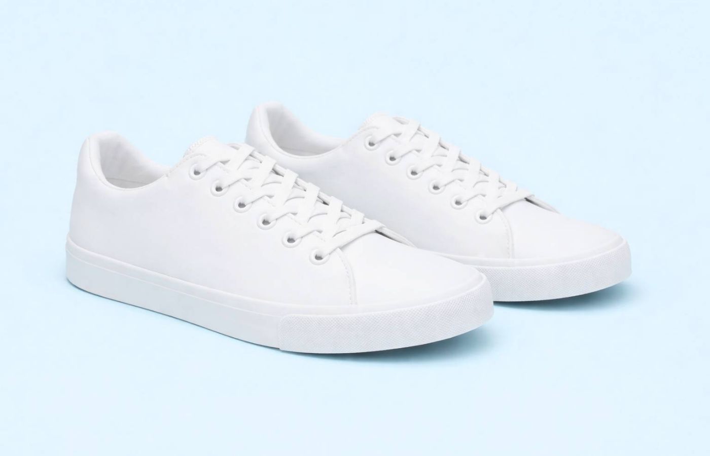 A white pair of women's sneakers.