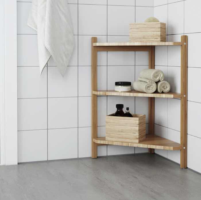 A bamboo corner shelf in a bathroom.