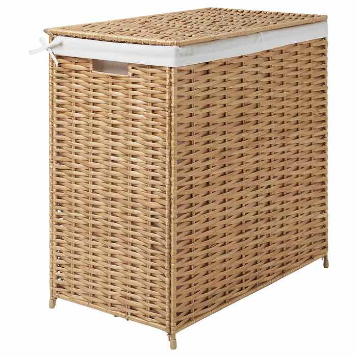 A brown woven laundry basket with white liner.