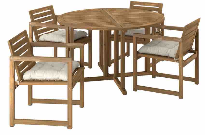 A round outdoor table with four arm chairs with cushions.