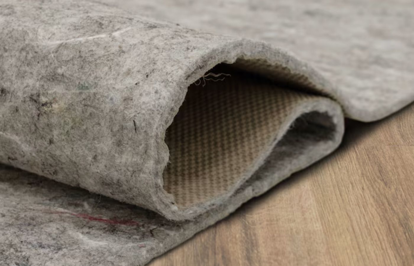 A rug pad on a wood floor.