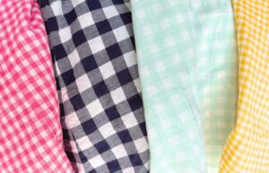 Pink, navy, seafoam, and yellow gingham patterns on clothing.