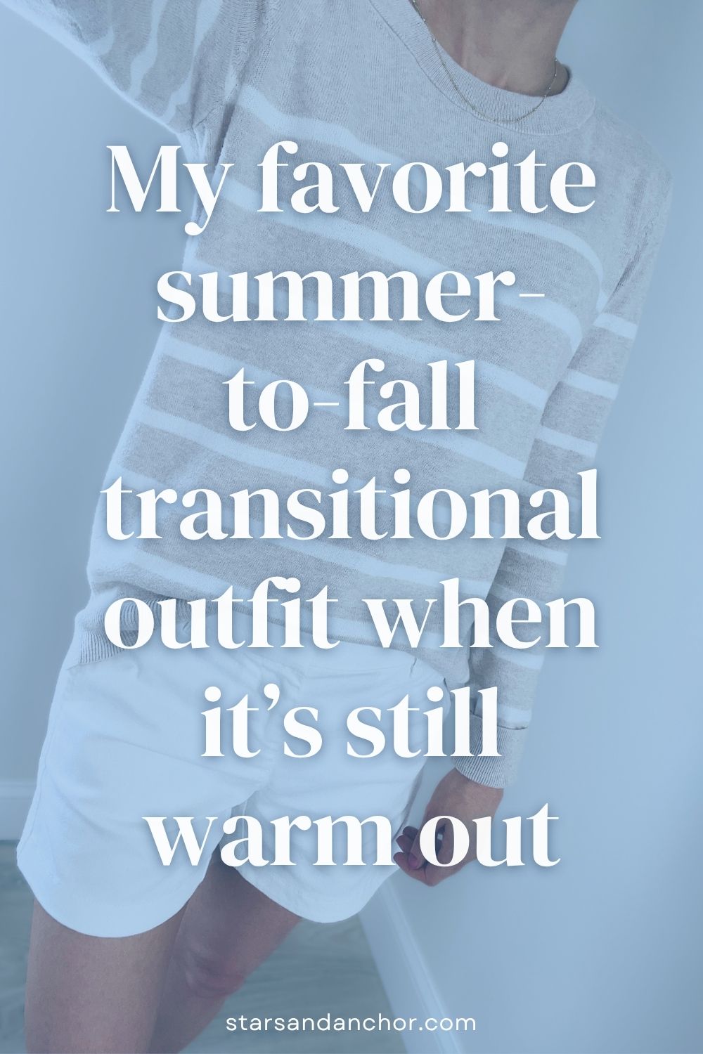 A woman wearing an oatmeal and white striped sweater with white chino shorts. Text over the image says: My favorite summer-to-fall transitional outfit when it's still warm out.